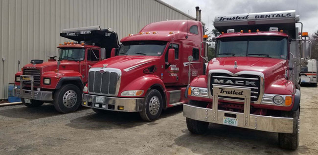 NH materials and equipment hauling trucks