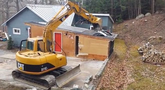 tearing down a shed with a CAT 311