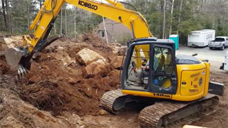 Kobelco 140SR digging at a garage site.